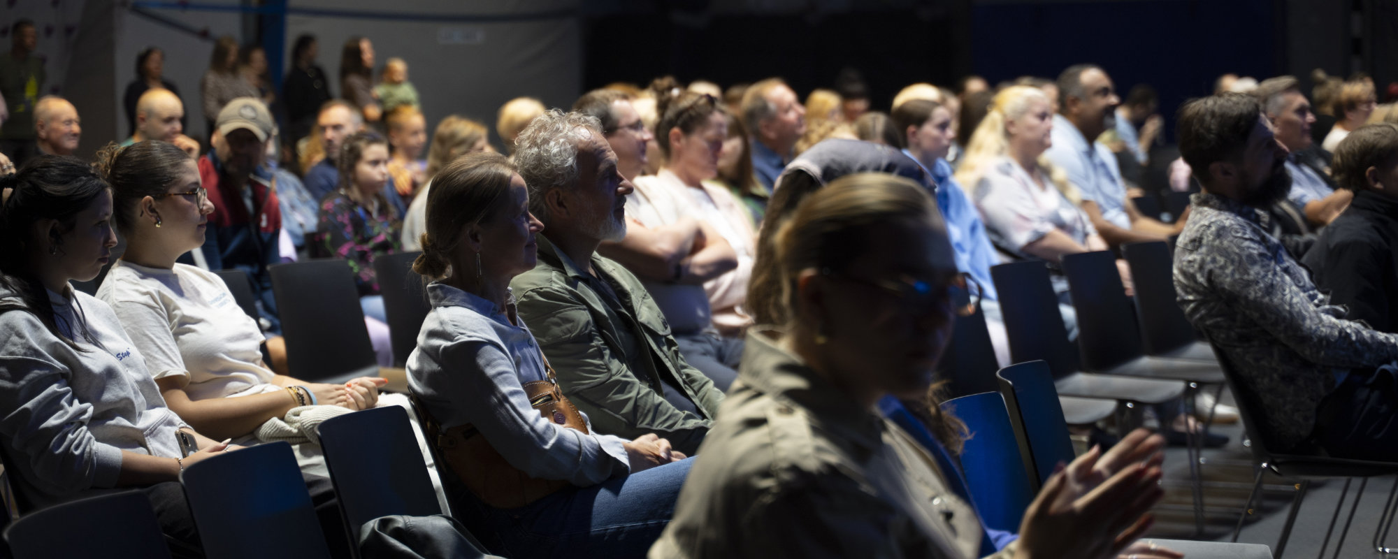 People of all ages sit in the hall during a service